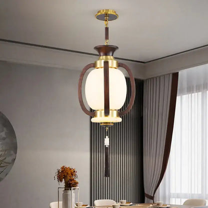 Decorbites chinese lantern chandelier with brass and dark wood frame, oval frosted glass shade, and decorative tassel