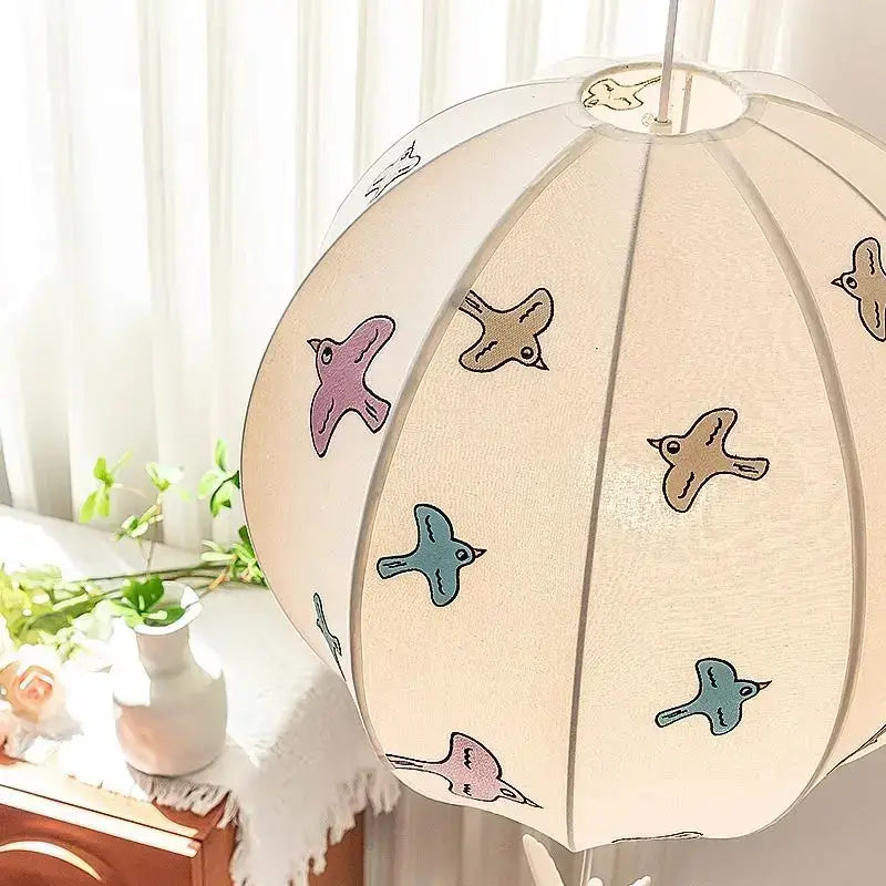 A soft cream-colored DecorBites Chinese medieval dove pendant light with delicate pastel bird illustrations