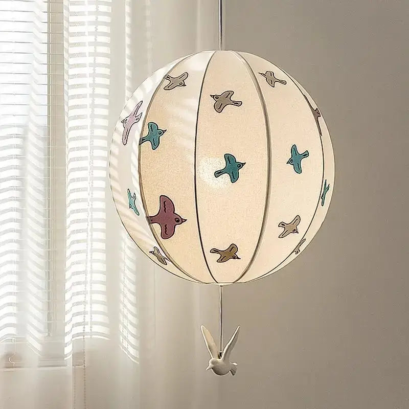 A cream-colored decorbites chinese medieval pendant light with chinese medieval dove embroidery hangs from ceiling