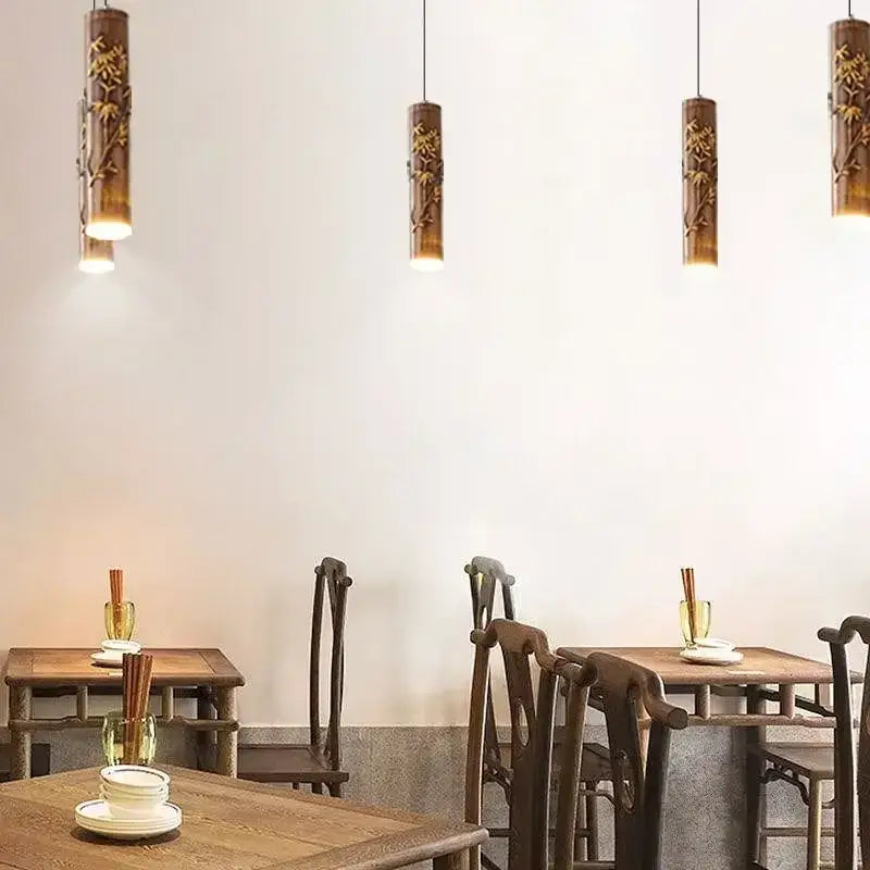 Decorbites chinese modern pendant light featuring golden bamboo branch carvings with warm diffused illumination