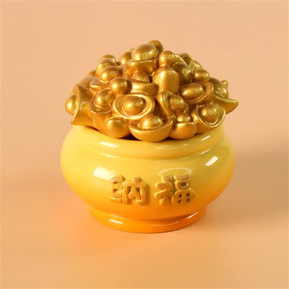 A glossy yellow ceramic pot with embossed chinese characters overflowing with golden coin figurines in mythology lion figurines decor