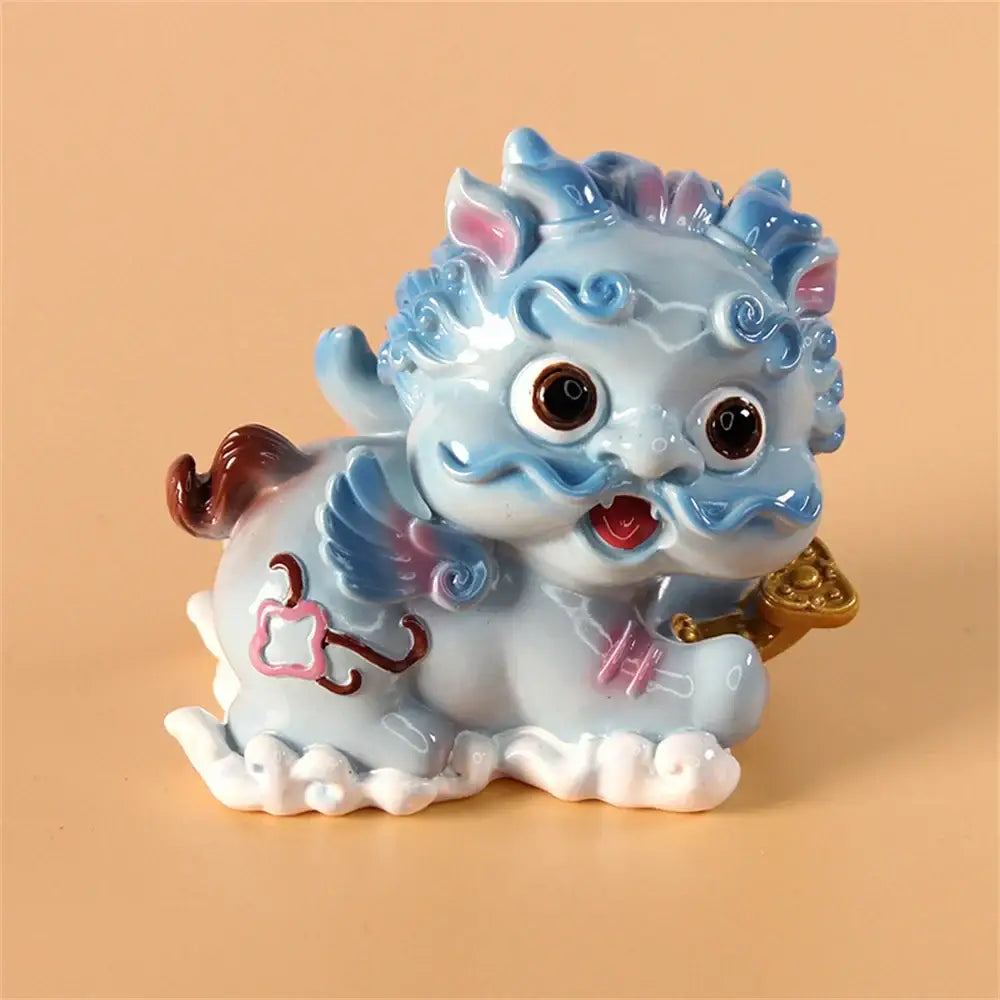 A light blue ceramic mythology lion figurine with pink and gold accents from DecorBites for luck and protection