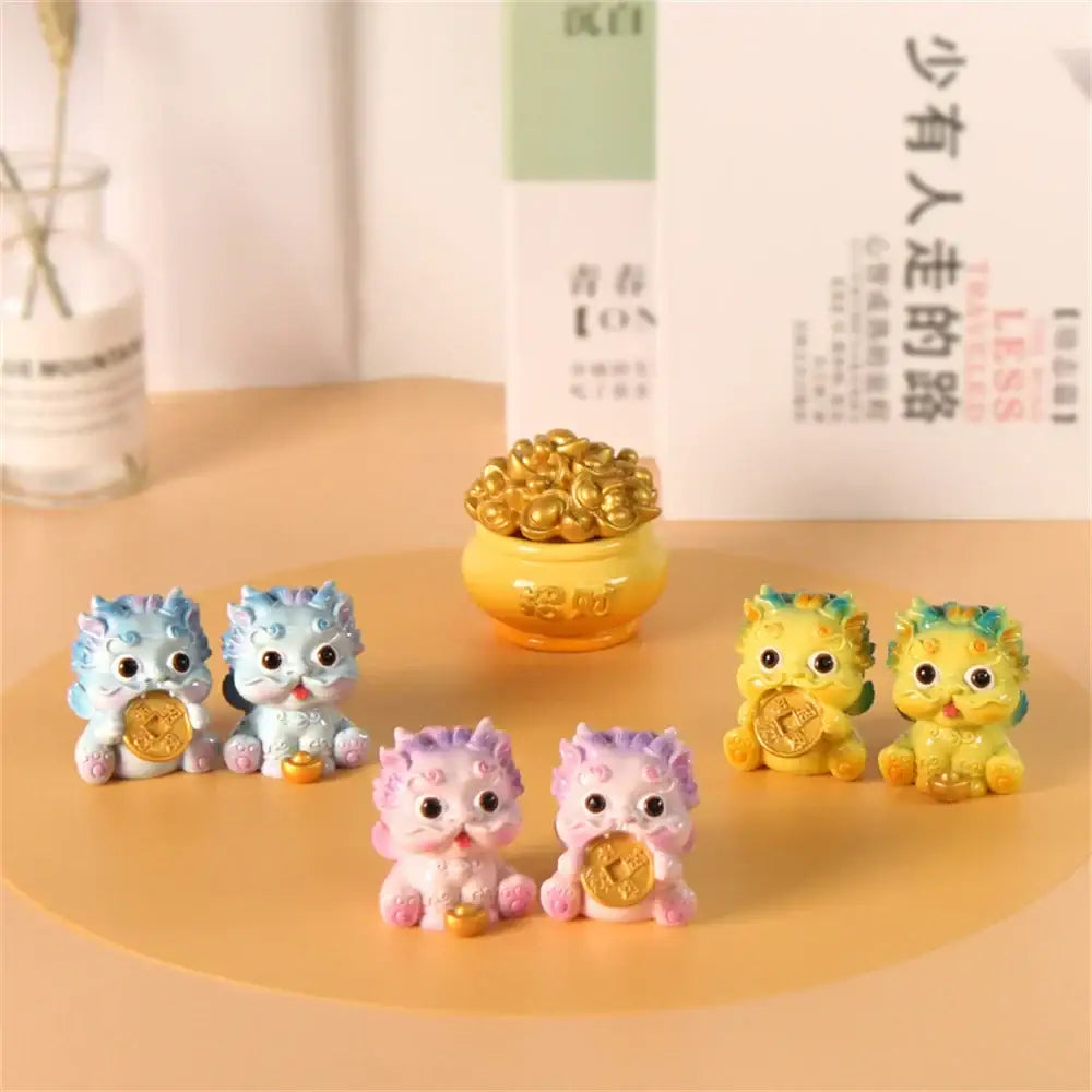 A set of colorful glossy resin mythology lion figurines from decorbites holding gold coins for luck and wealth