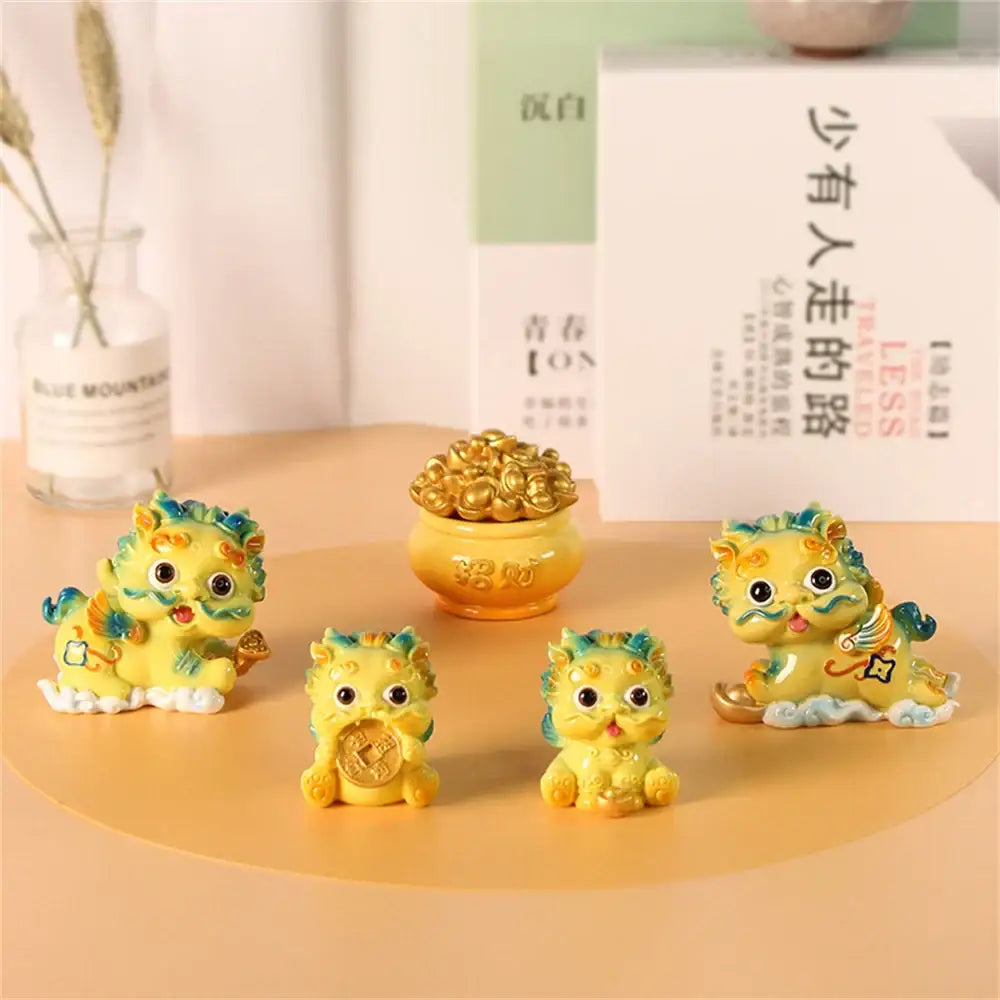 DecorBites™ yellow resin mythology lion figurines with green and blue accents holding gold coins for luck and wealth