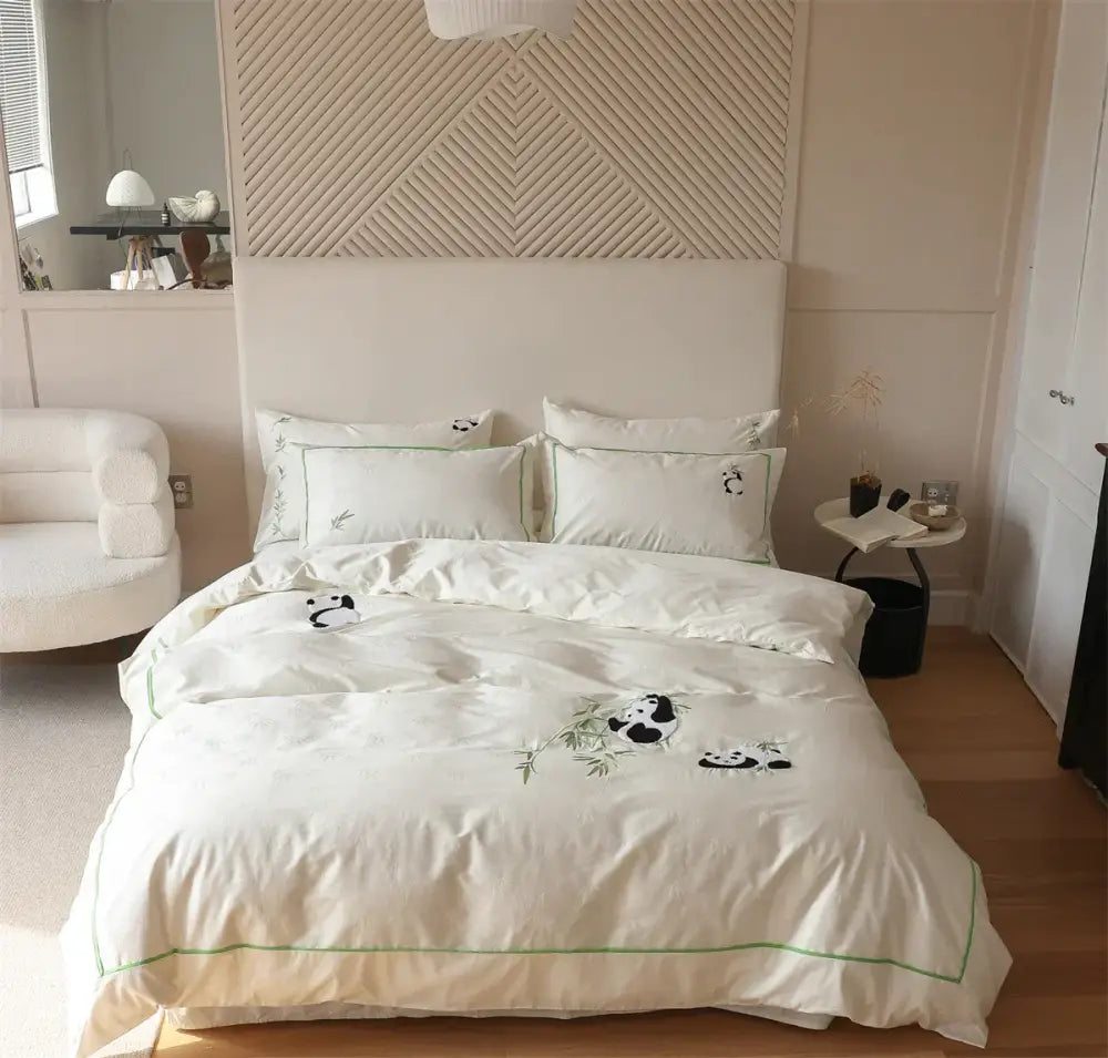 Cream-colored satin duvet cover set with embroidered black and green panda motifs in bamboo jacquard fabric
