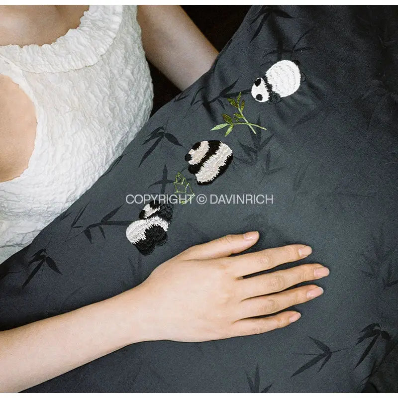 Dark gray pillowcase with embroidered panda and bamboo motifs in black white and green thread in bamboo jacquard duvet cover set