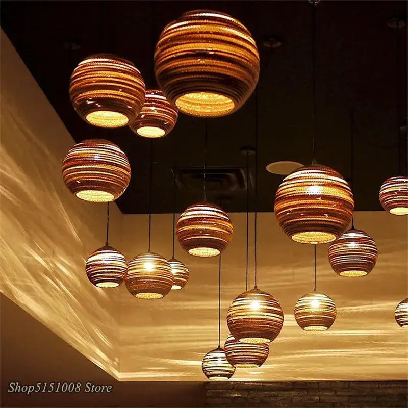 Warm-toned spherical pendant lights with concentric striped patterns made of woven cardboard by DecorBites pendant lights