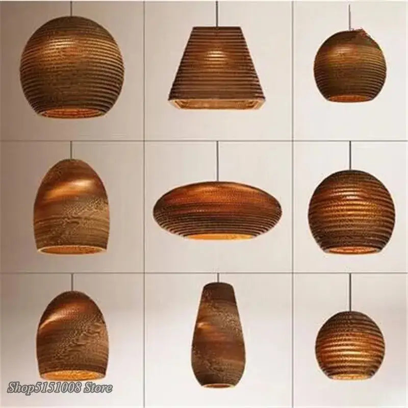 Warm-toned ribbed paper lanterns in various shapes and sizes from DecorBites pendant lights collection in cardboard