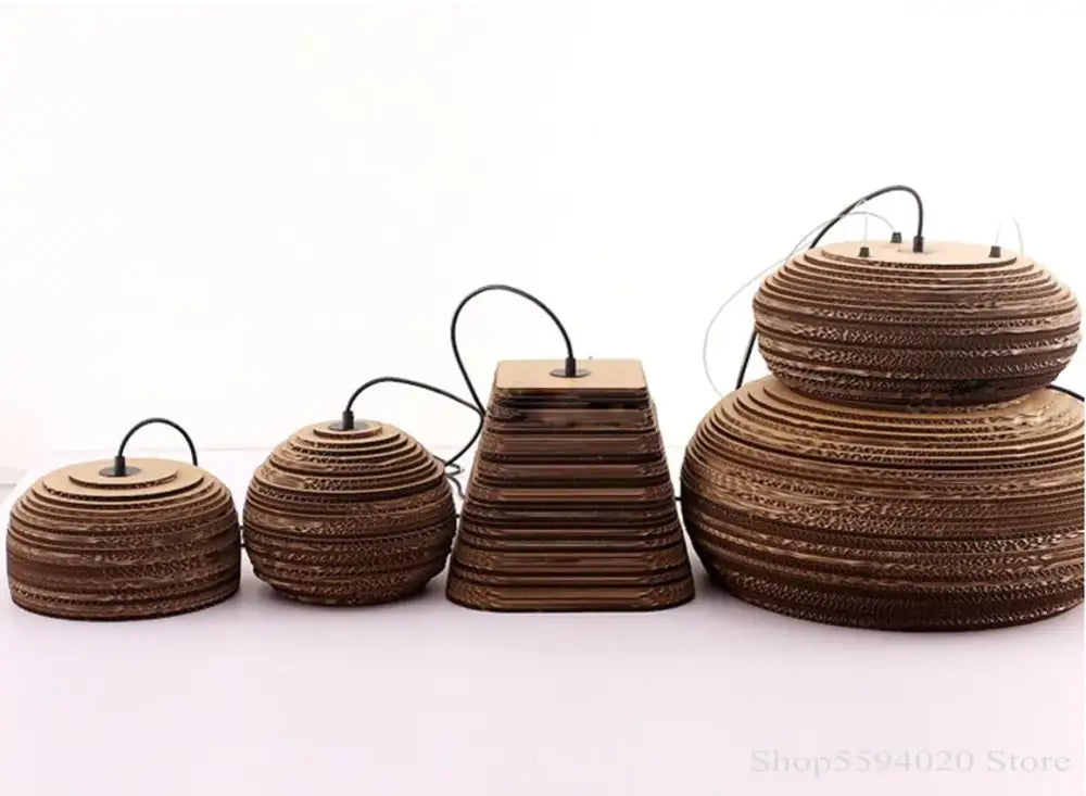 Set of four brown corrugated cardboard paper pendant lights with tiered design and black cords for southeast asian style decor