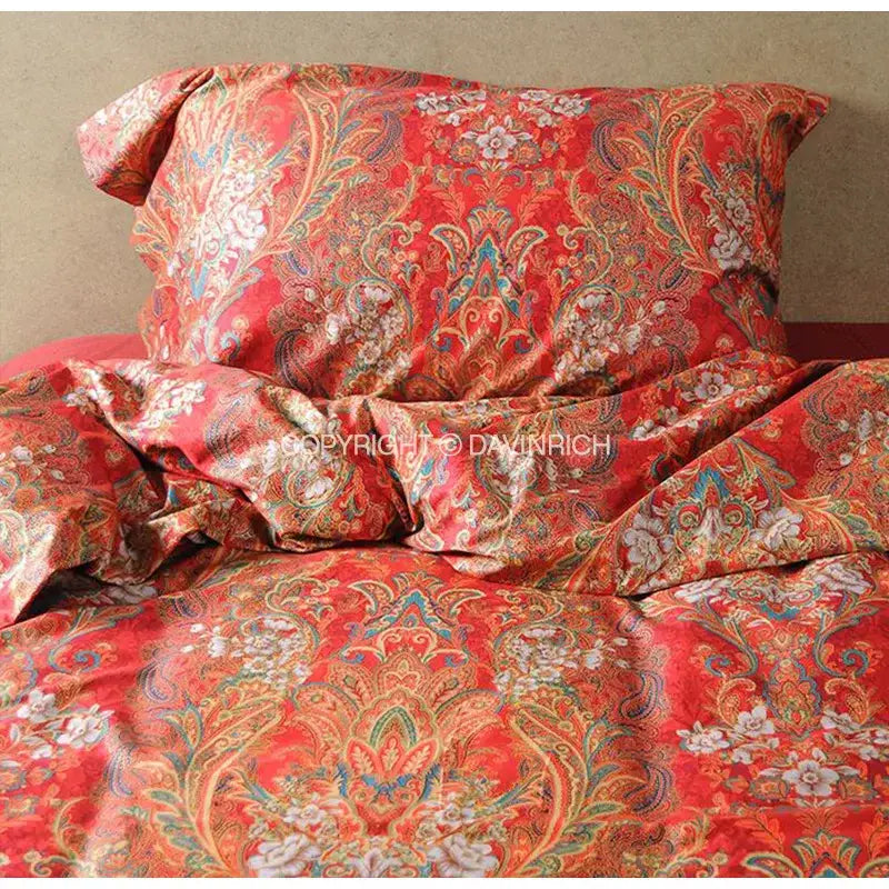 Red paisley-patterned satin cotton wedding duvet set with gold blue and white floral accents by decorbites
