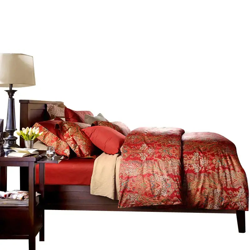 Red and gold paisley-patterned duvet set in red satin cotton for satin cotton wedding by decorbites on dark wood bed