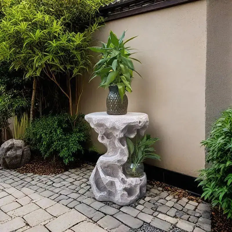 Gray stone resin garden pedestal with textured organic design and integrated water feature for modern living room decor