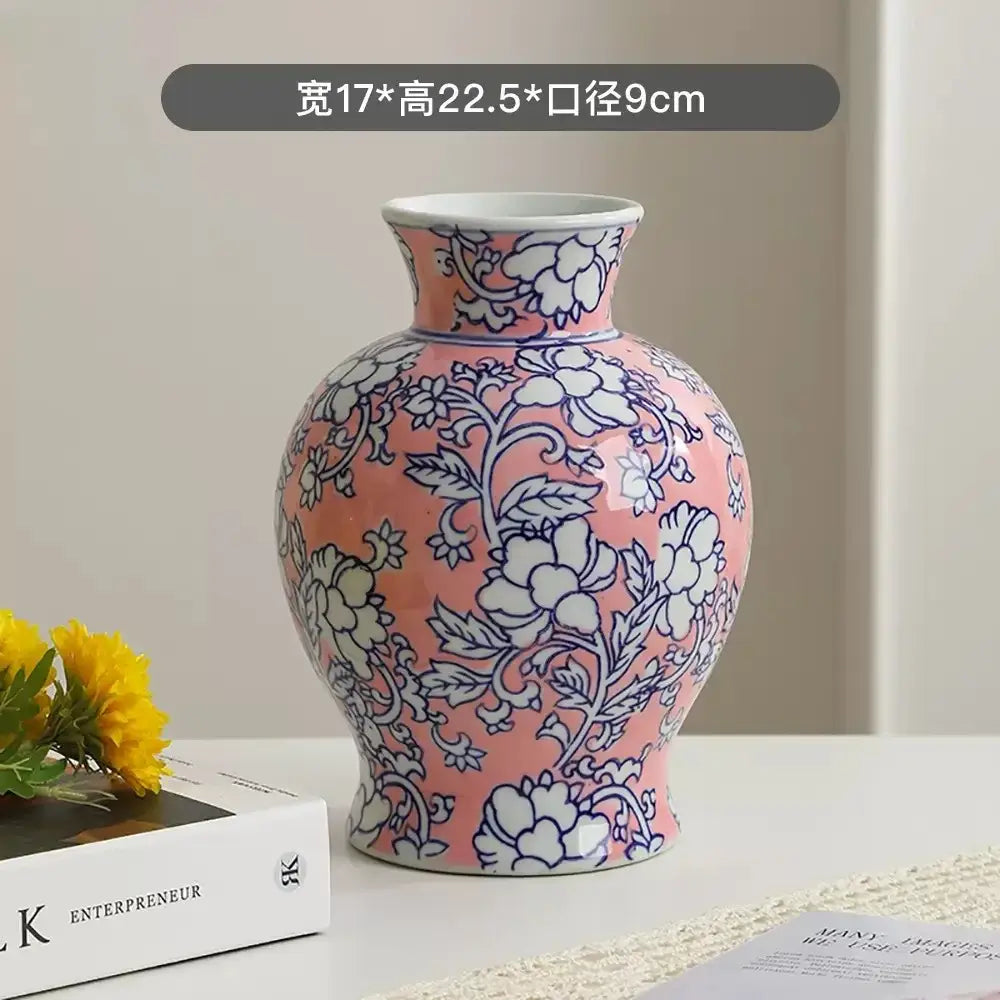 A pink ceramic pink ceramic vase featuring intricate blue and white floral patterns from decorbites chinese retro collection