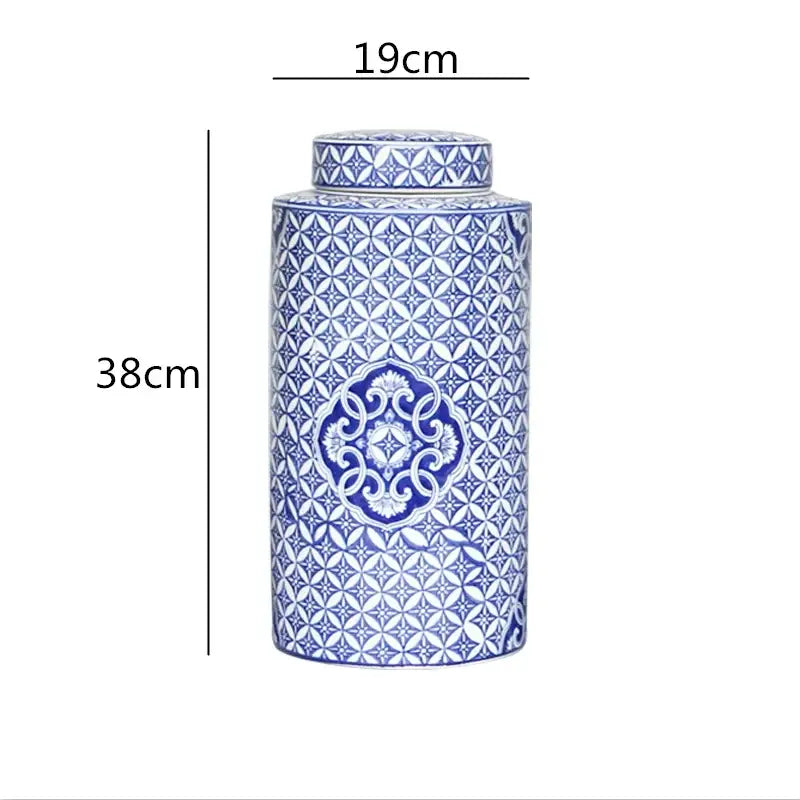 A tall porcelain decorbites chinese retro tea canister with blue and white geometric patterns and a matching lid