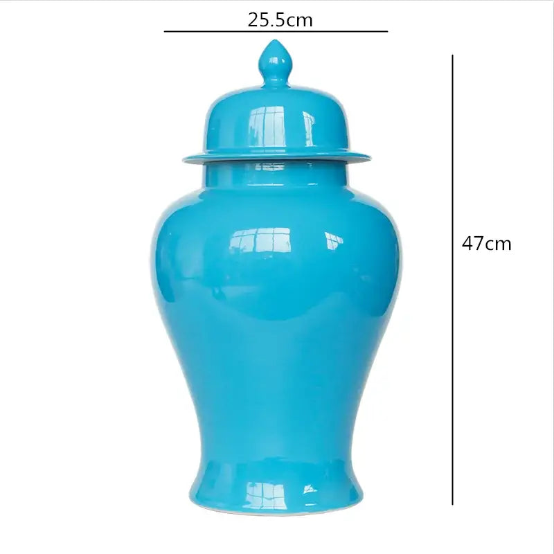 A glossy turquoise ceramic general jar vase with matching lid and decorative finial for home decor and storage