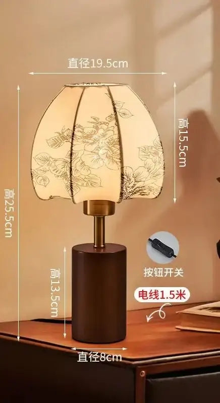A warm-toned bedside lamp with chinese retro patterned fabric shade and wooden base by decorbites chinese retro