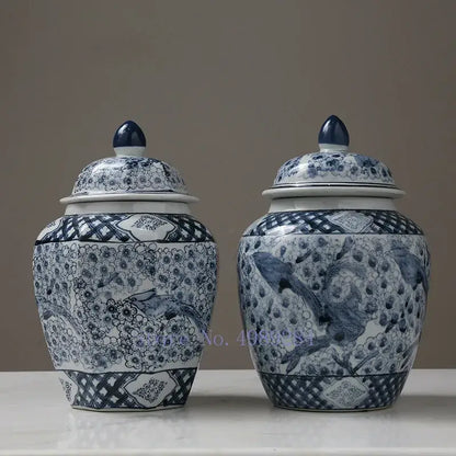 Two elegant blue and white porcelain storage tank vases with floral bird motifs and matching lids by DecorBites™
