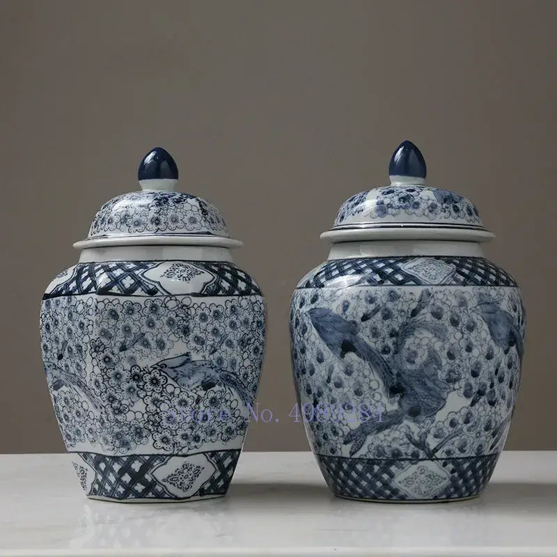 Two elegant blue and white porcelain storage tank vases with floral bird motifs and matching lids by DecorBites™