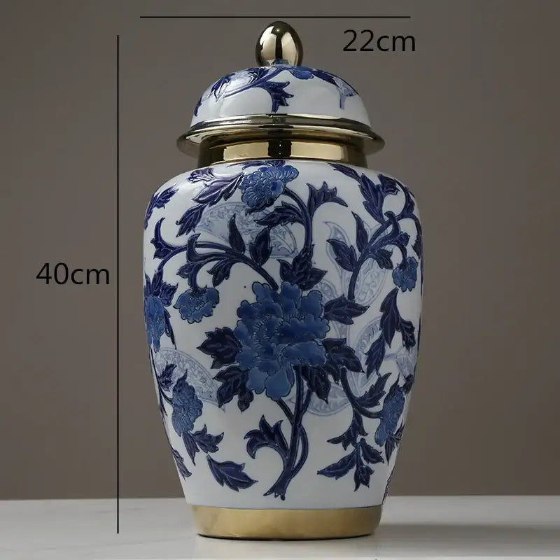 A classic blue and white porcelain storage tank vase with gold-toned metal accents for modern home decoration
