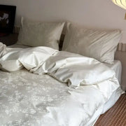 Cream-colored satin duvet cover set with delicate white floral embroidery from decorbites™ cotton jacquard luxury bedding