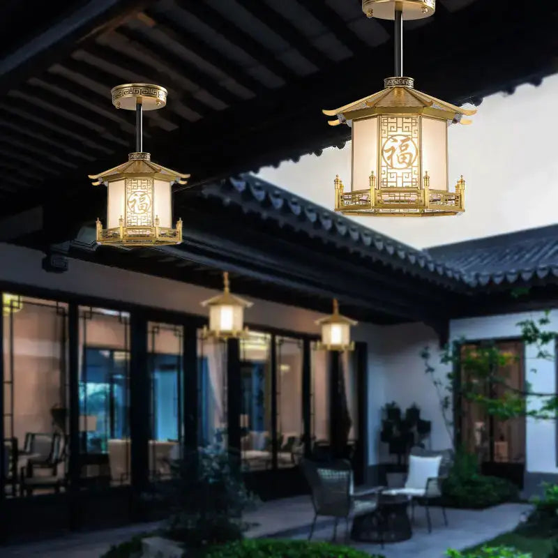 Golden decorbites chinese style pendant light with intricate traditional designs glowing on a chinese style balcony