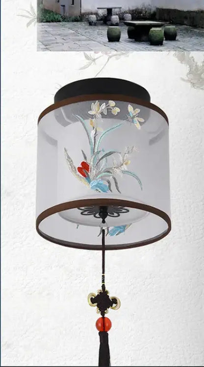 A decorbites chinese style ceiling lamp with a translucent cylindrical design embroidered with pastel flowers and birds