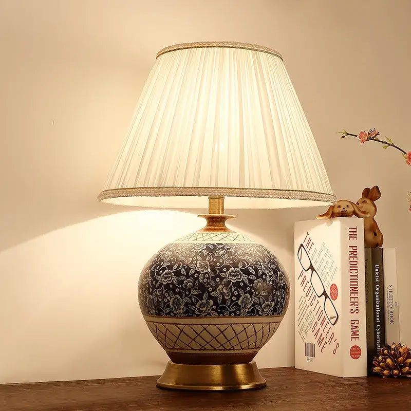 DecorBites™ Chinese style ceramic copper table lamp with black and white floral pattern and off-white pleated shade