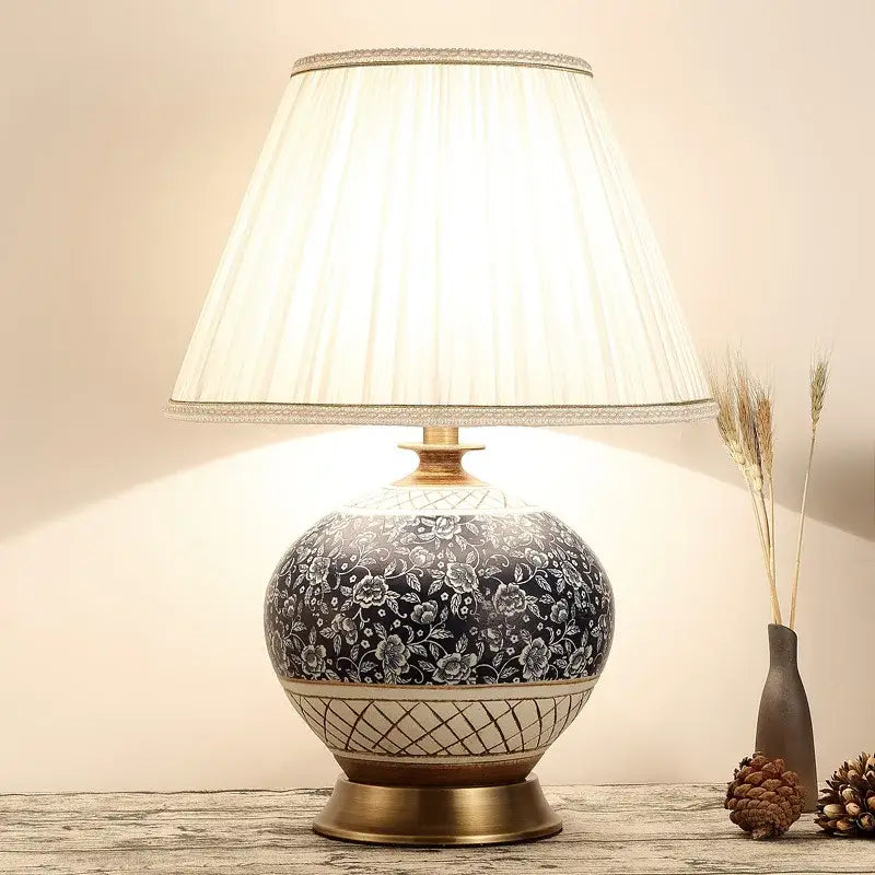 DecorBites™ Chinese style ceramic copper table lamp with black floral patterns and cream fabric shade for living room