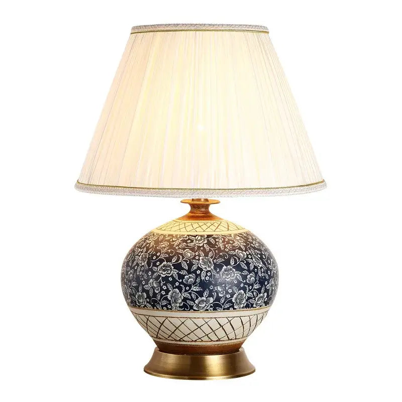 Elegant navy blue ceramic copper table lamp with white floral patterns and cream pleated shade for living room decor
