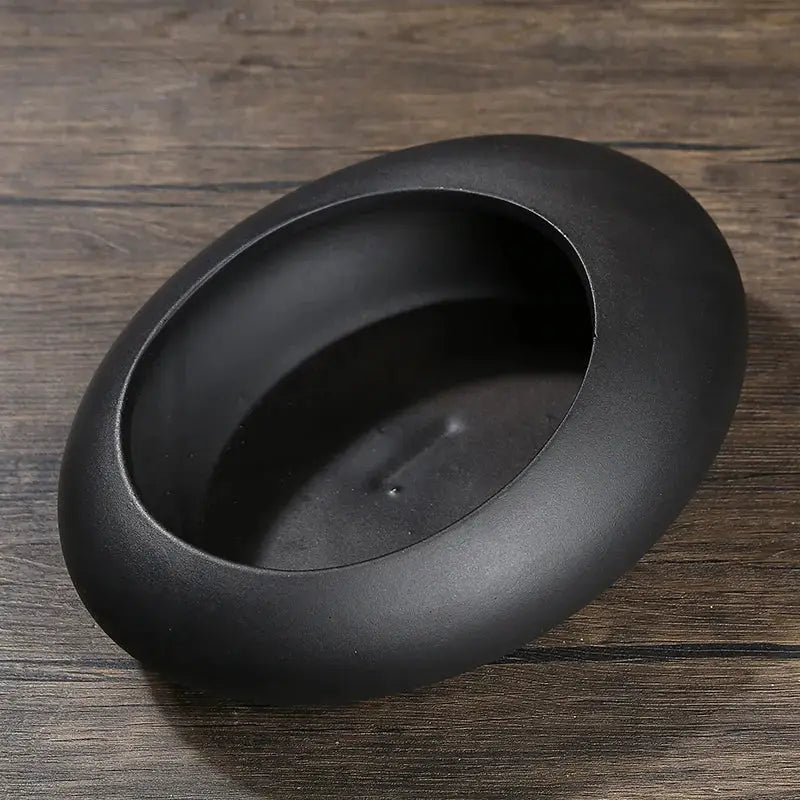 Black matte ceramic flowerpot vase with oval shape smooth rim and shallow interior for bonsai floral decor