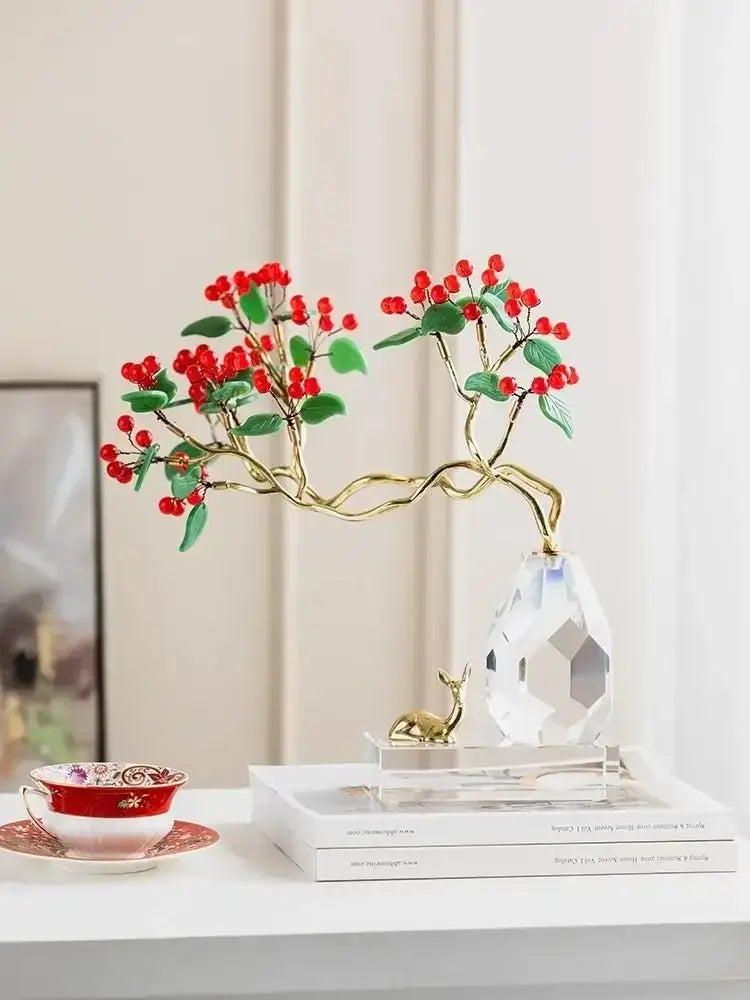A delicate gold-toned decorative branch with red berries and green leaves on a crystal base in decorbites chinese style crystal ornaments