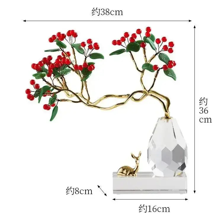 Golden branch crystal ornament with red berries and green leaves on faceted base beside golden deer figurine decorbites chinese style