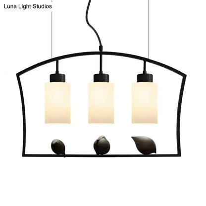 Black DecorBites™ cylinder island light fixture with three frosted glass shades and decorative bird figurines ceiling lamp