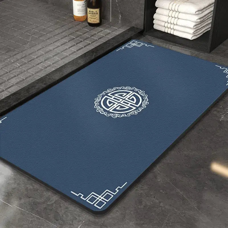 Blue DecorBites™ entry door mat with white traditional Chinese knot design and decorative corners made of diatom mud