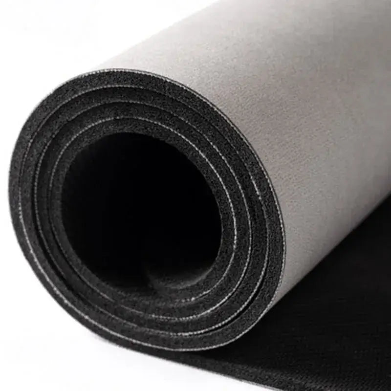 A rolled-up gray decorbites™ chinese style diatom mud entry door mat with a black textured underside and visible stitching