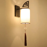 DecorBites™ warm-toned cloth wall sconce with e27 bulb, matte black frame, geometric accent, and tassel for living rooms