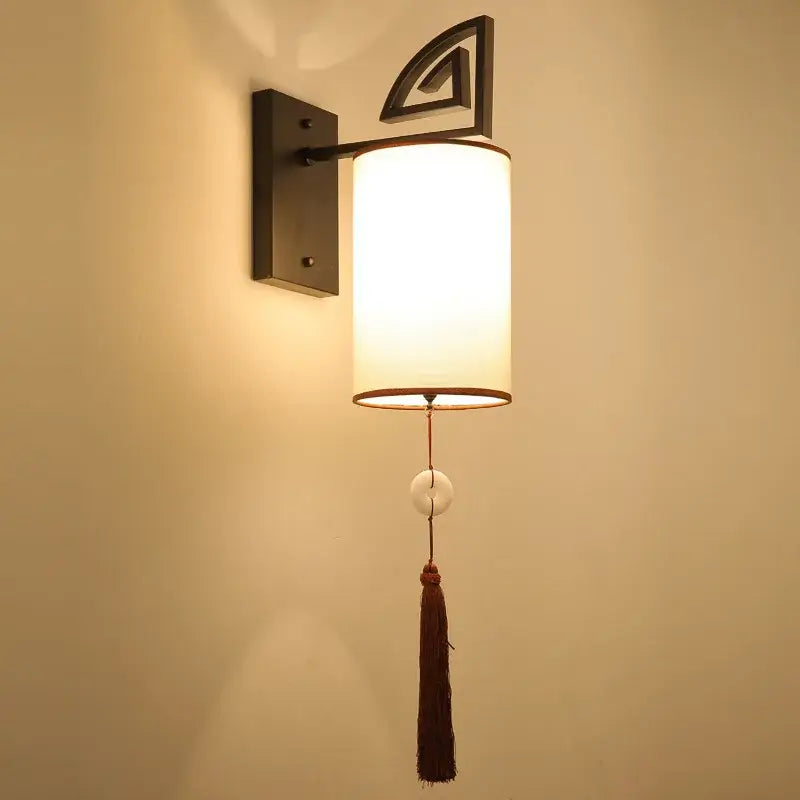 DecorBites™ warm-toned cloth wall sconce with e27 bulb, matte black frame, geometric accent, and tassel for living rooms