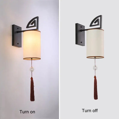 Black metal wall sconce with cylindrical off-white cloth shade and brown tassel decorbites e27 cloth wall sconce