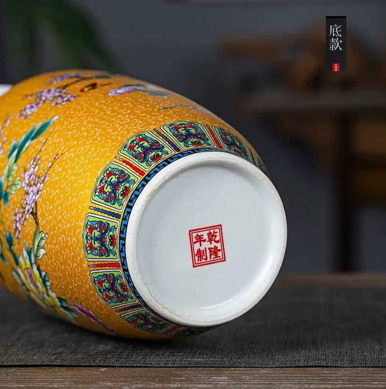 A vibrant yellow enamel colored vase by DecorBites™ featuring intricate floral and bird motifs with geometric patterns