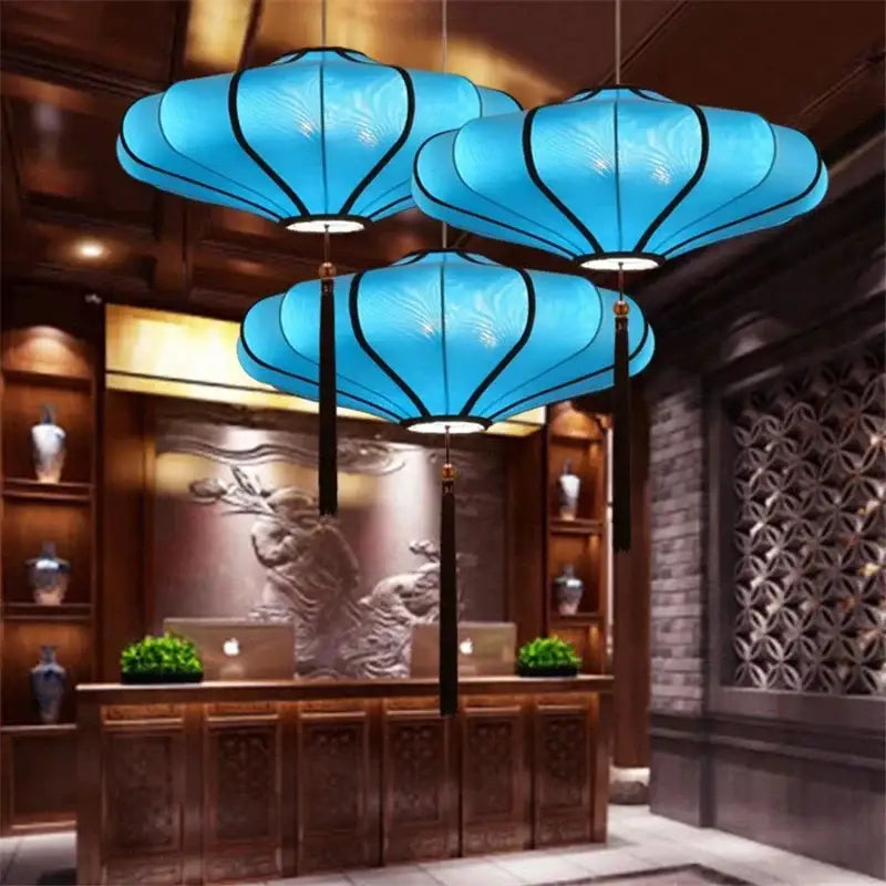 Three vibrant blue decorbites chinese style flower pendant lights with black trim and tassels for home lighting