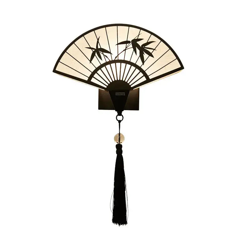 Elegant black and cream iron art wall lamp with bamboo leaf fan design and hanging tassel for living room decor