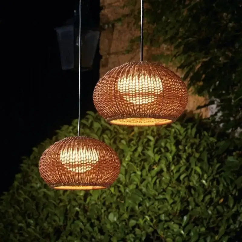 Warm-toned woven rattan weaving pendant lights with textured spherical design for outdoor courtyard and garden decor