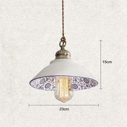 White ceramic hanging lamp with blue floral pattern inside, brass top, and exposed bulb by DecorBites Chinese style porcelain