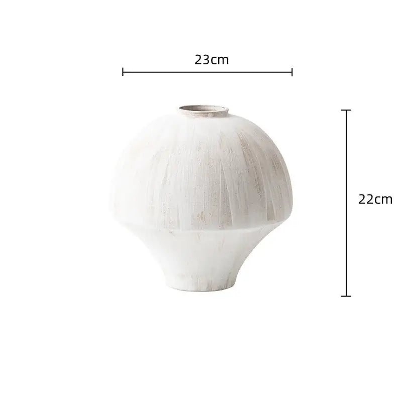 White hand-painted ceramic retro porcelain vase with rounded body and flared base for artistic home decoration