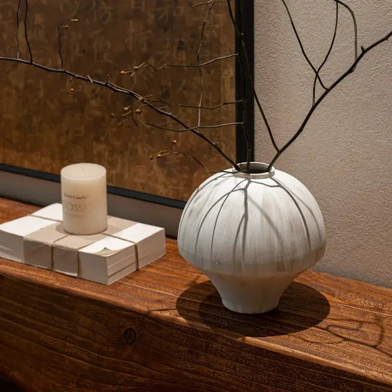 A white ceramic retro porcelain vase with a rounded bulbous body and subtle radial striations for home decor
