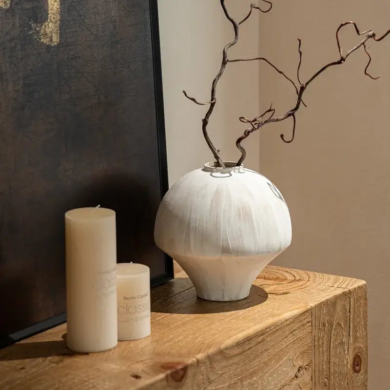 DecorBites™ white textured retro porcelain vase with rounded body and narrow opening holding dark twisted branches