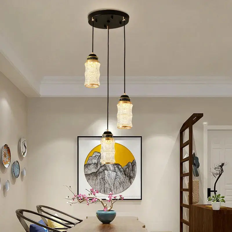 Three pendant lights with textured glass and black metal fixtures in decorbites™ spiral staircase chandelier for villa use