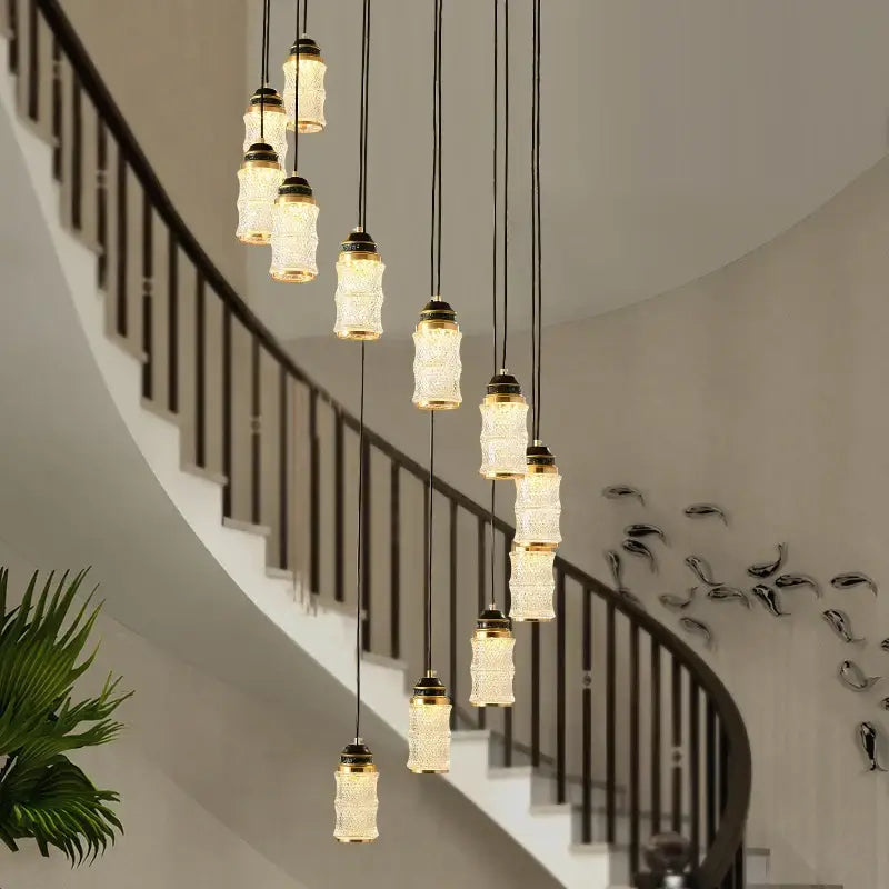 DecorBites™ spiral staircase chandelier with warm-toned textured glass shades and dark metal fixtures for villa lighting