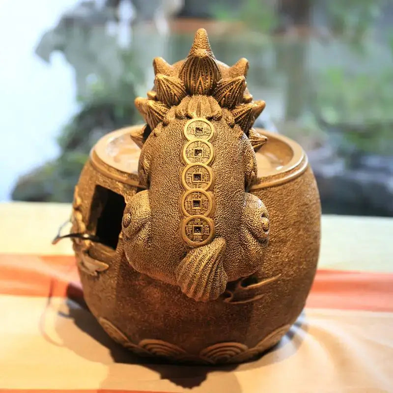 Bronze-colored ceramic frog figurine with lotus leaf and coin detailing from decorbites chinese style wealth attracting ornaments