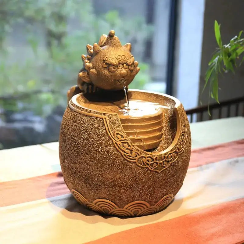 Golden ceramic lion-head fountain with intricate carvings and flowing spout from decorbites chinese style wealth ornaments